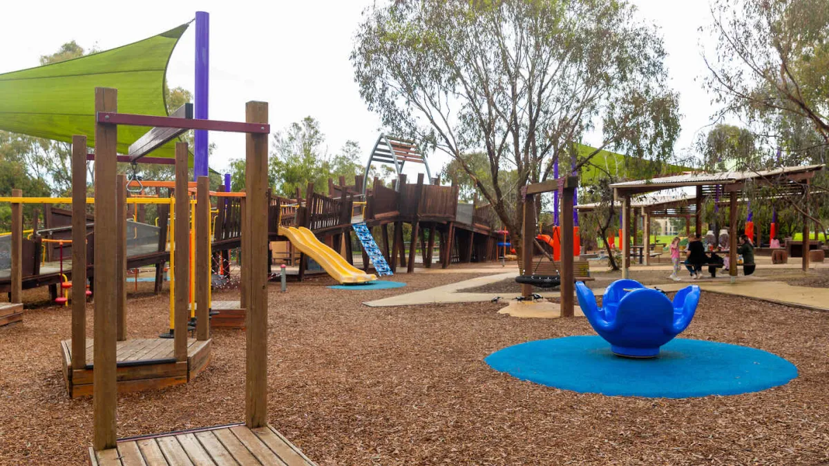A playground featuring a slide and jungle gym
