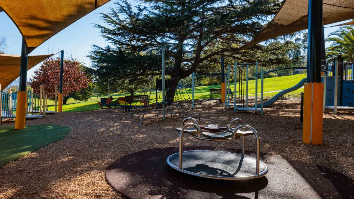 Children's playground featuring a mini merry-go-round and slide. 