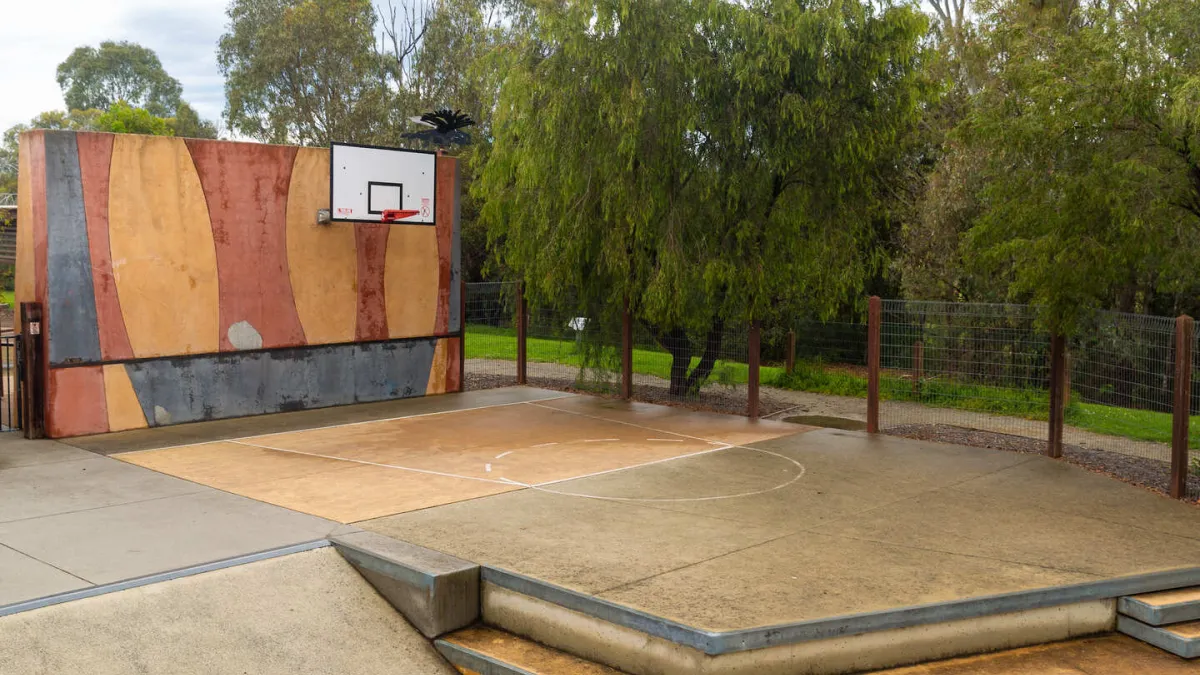 A basketball ring on a small court
