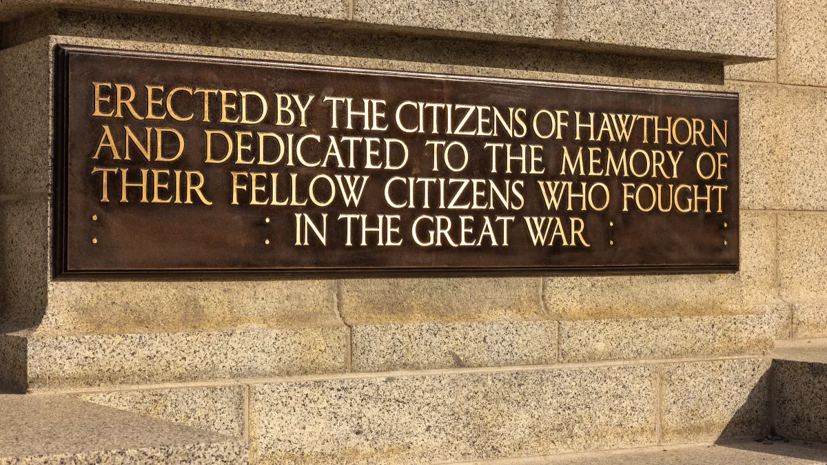 Permanent commemorative plaque located at the base of the memorial.