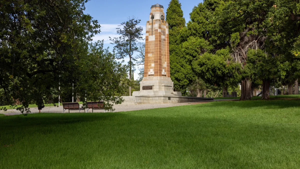 Side view of the restored St James Park war memorial with seating facing the memorial.
