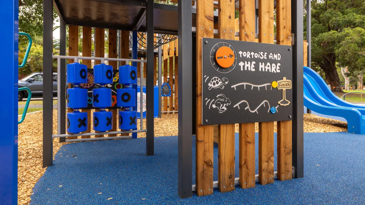 Timber play space with blue rubber floor at a playground
