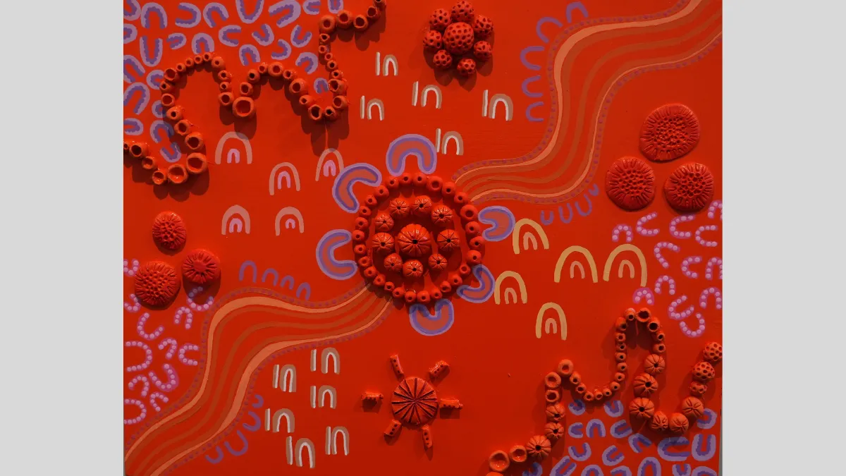 Artwork featuring red paint and beads
