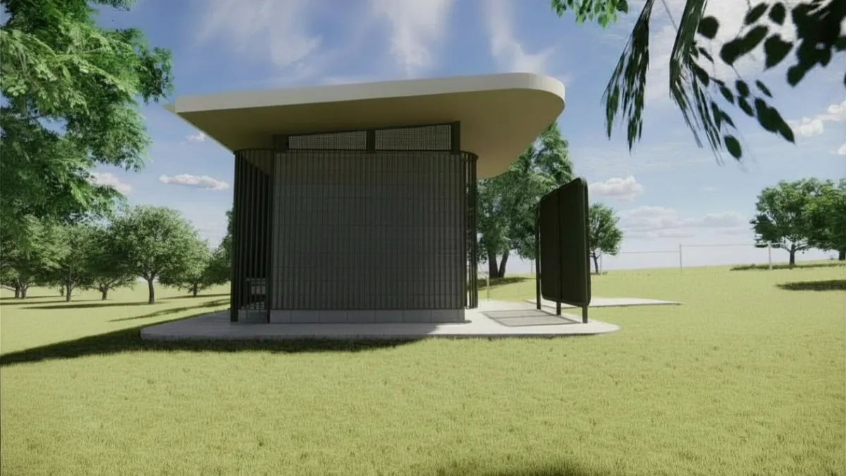 Side view of a green and cream toilet block. Large canopy trees surround it.