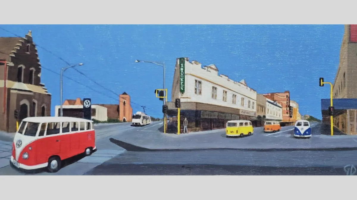 A painted street scene featuring several vintage Volkswagen vans driving through an intersection. A red-and-white van is in the foreground, with yellow, orange, and blue vans further down the road. The street is lined with older buildings, including a white corner building with a green sign, and a church-like structure on the left. The sky is bright blue.