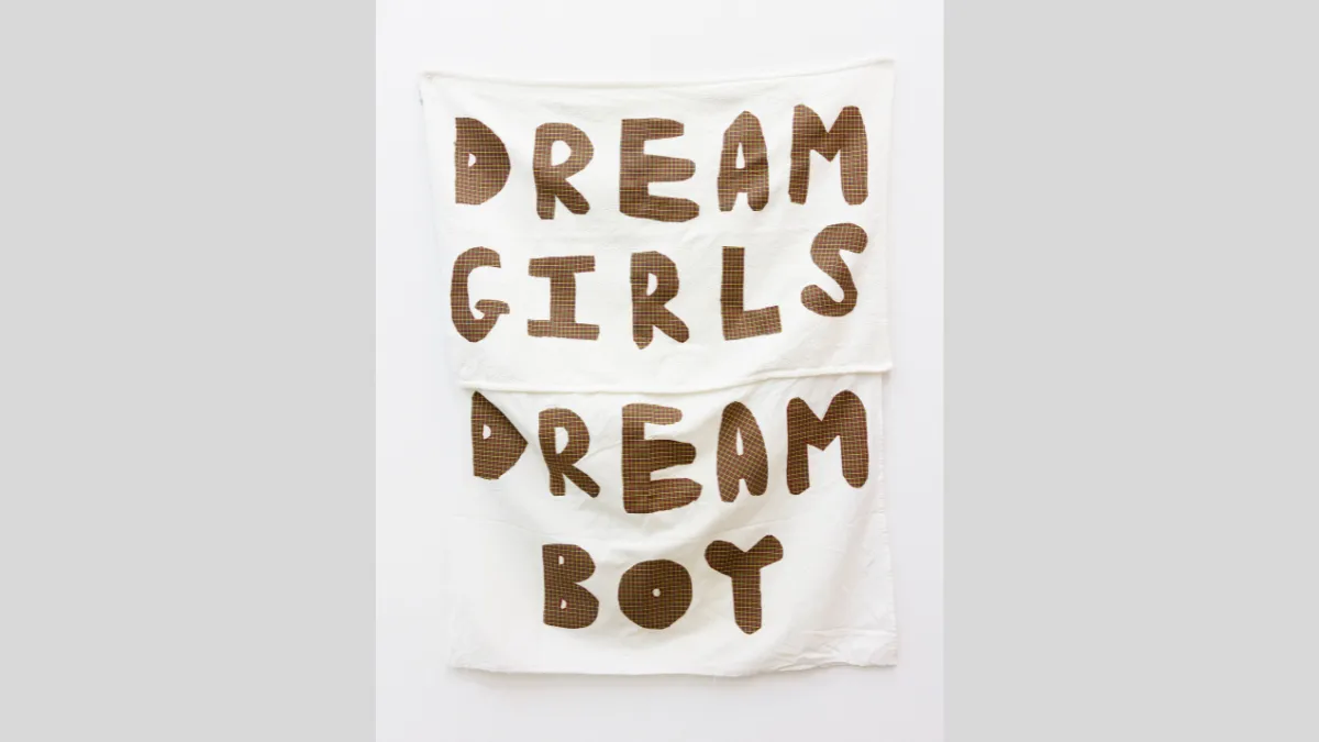 Fabric banner that says 'Dream girls dream boys'