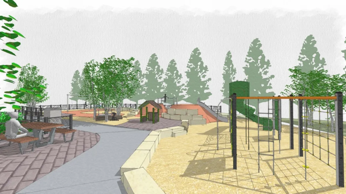 A picnic table on the left overlooks the playground climbing frames, slides and cubby house. The area is surrounded by trees