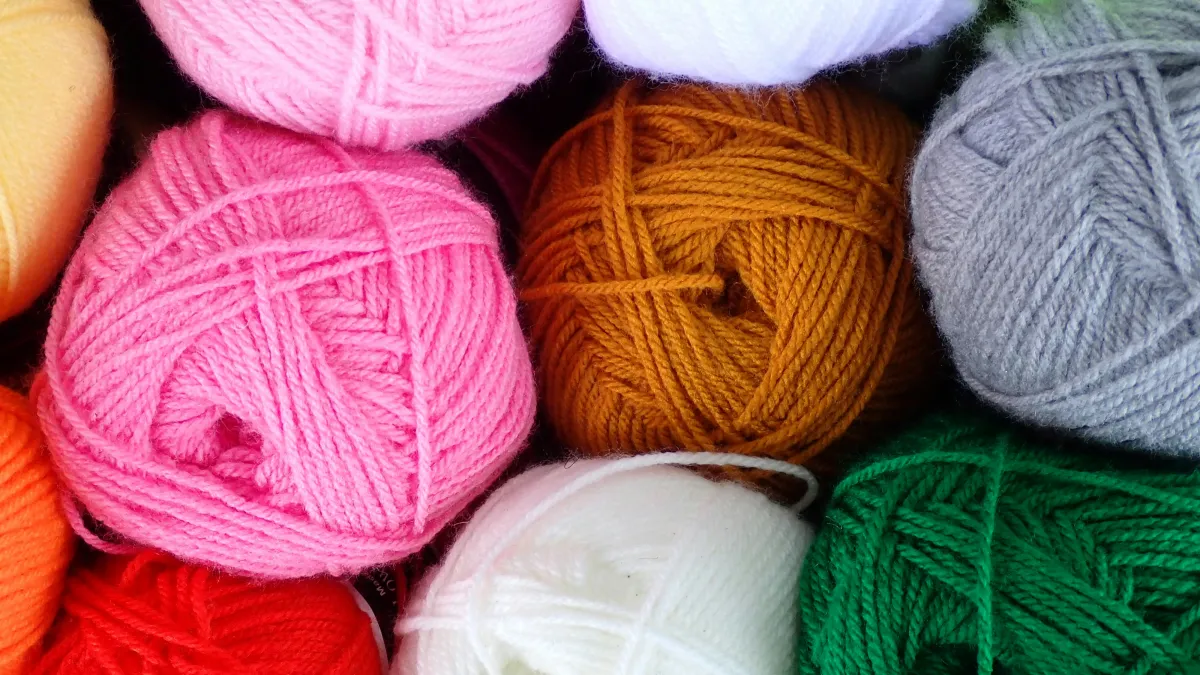 Balls of coloured wool sitting next to each other