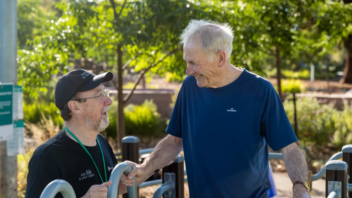 Two men using the exercise equipment