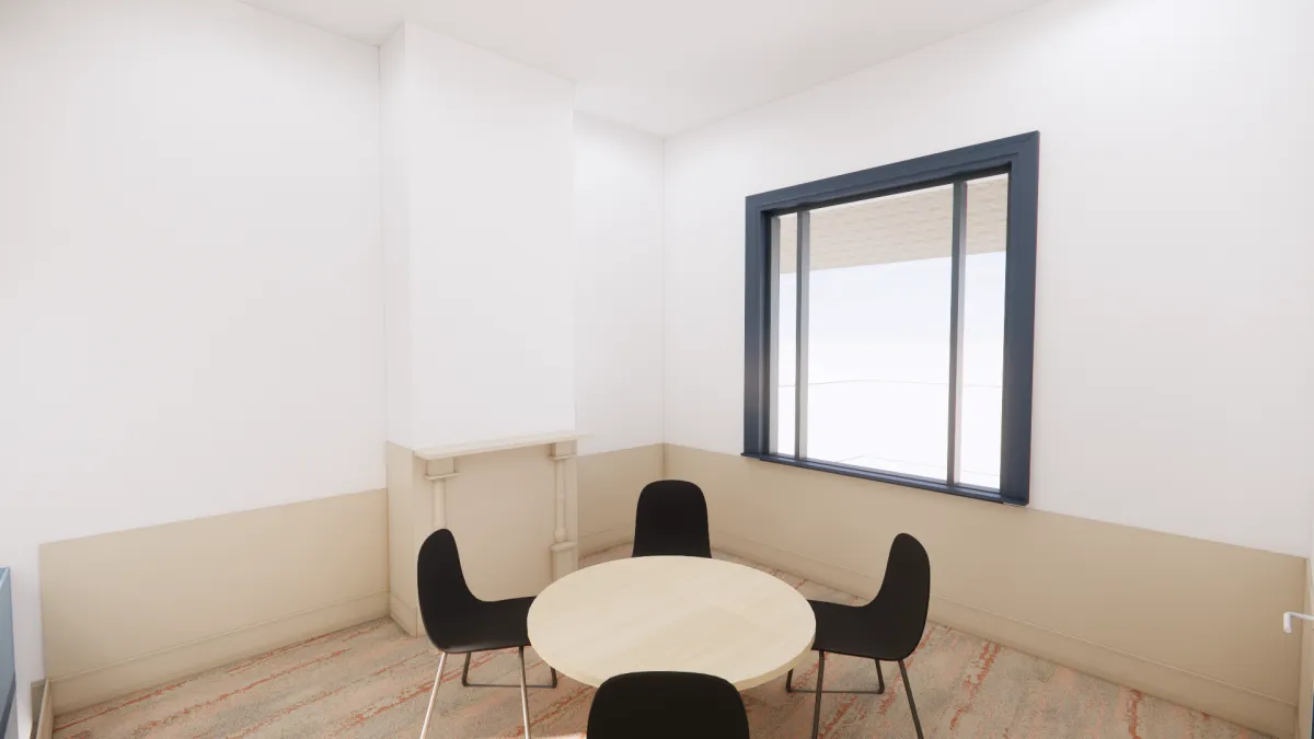 A small, carpeted room with a round table and 4 chairs. There's a large window letting in lots of light.