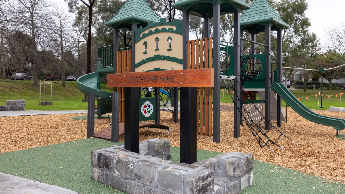 A wooden, child's climbing play unit shaped like a castle