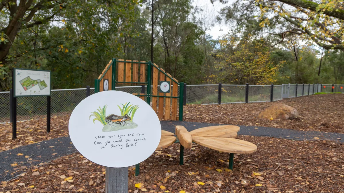 Playground signage featuring a frog painting