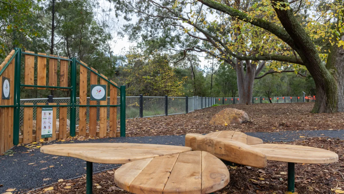 A timber seat at a playground in the shape of a butterfly 
