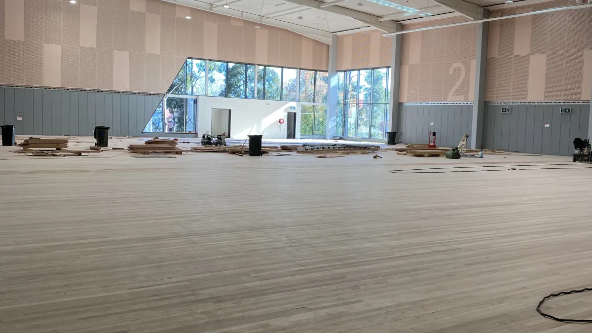 A large open under constrution space with wooden floors. 
