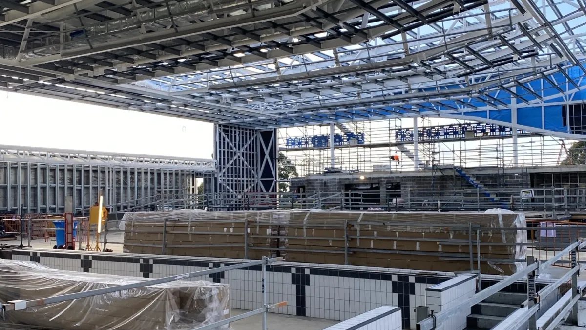 An underconstruction space with visible roof framing and walls. 