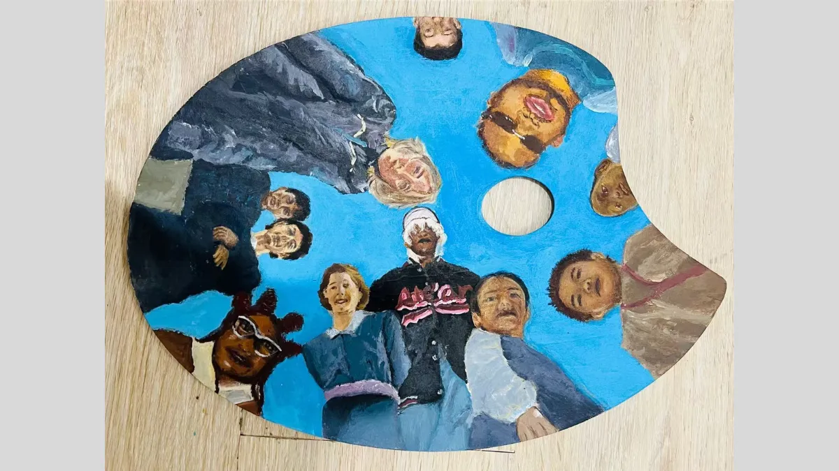 Painting of a group of people looking down on a paint palet