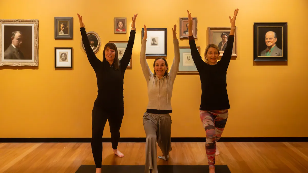 three women with arms raised in gallery