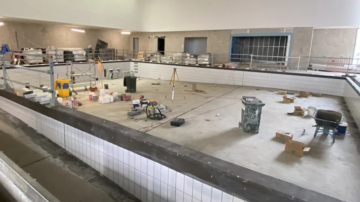 An indoor pool in the process of being tiled