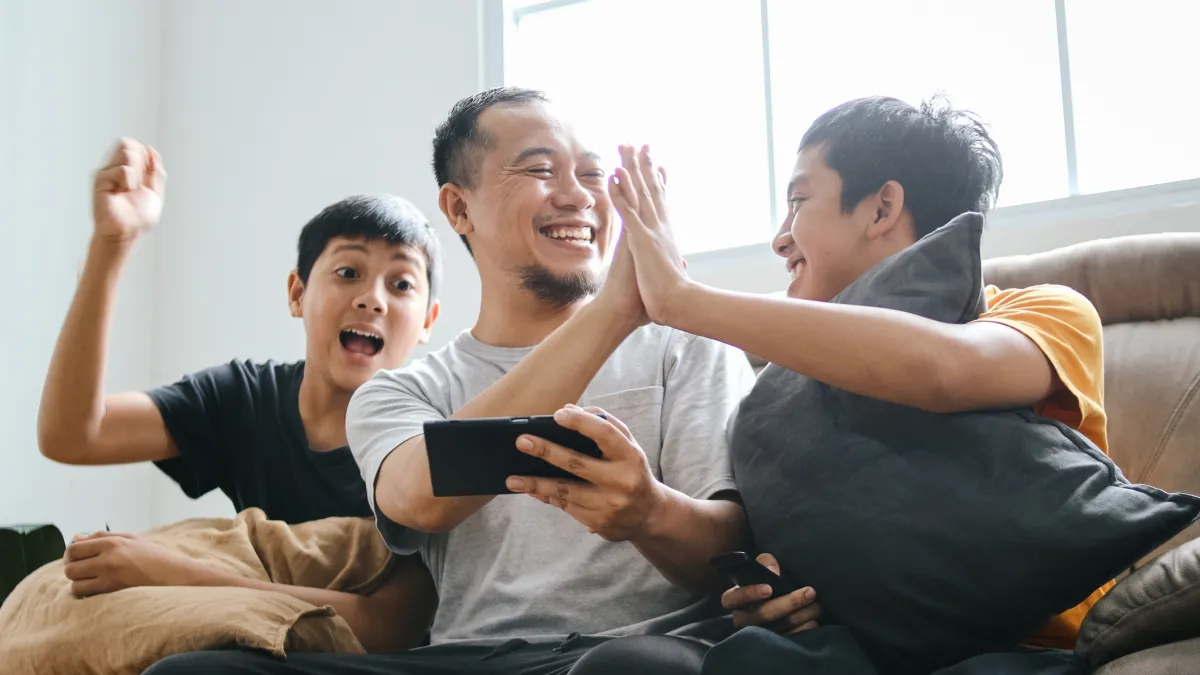 Adult doing high five with teen