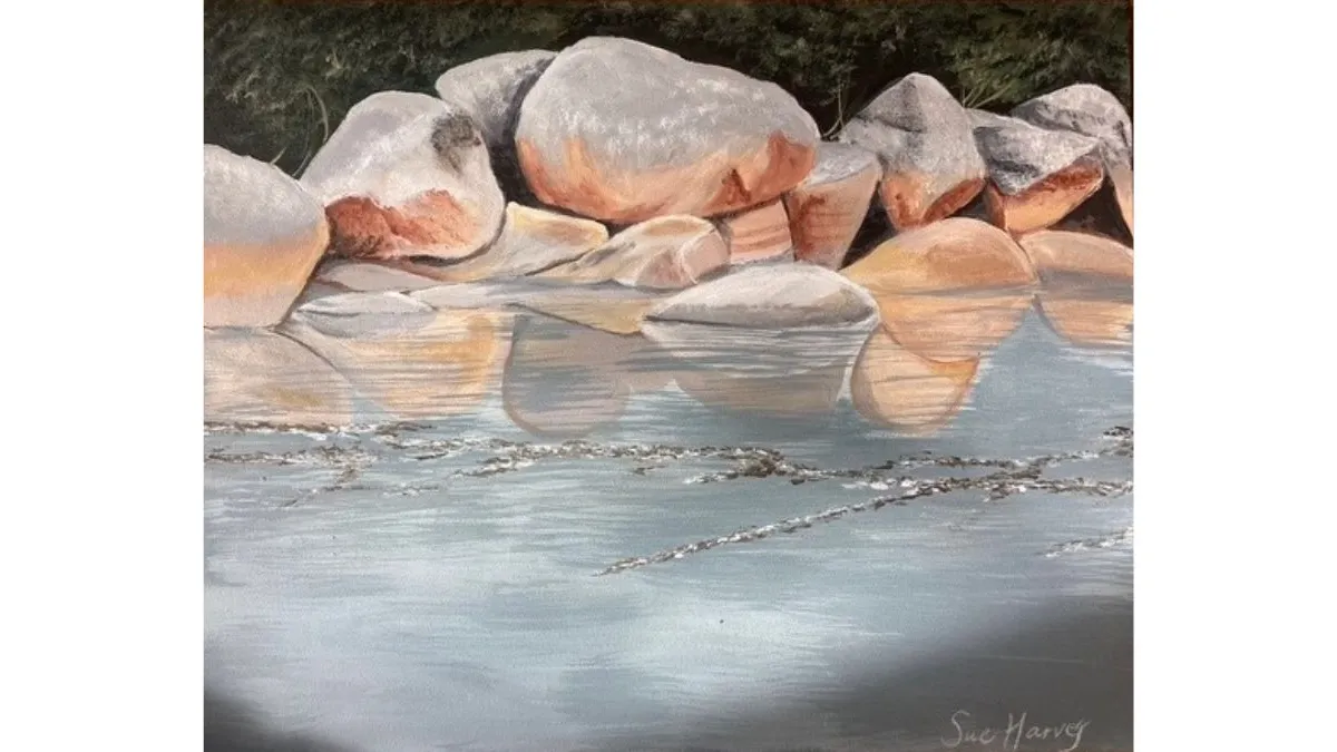 Painting of large pale boulders resting beside still water. The rocks are reflected on the water’s surface, with soft pink and grey tones contrasting against a dark, wooded background.