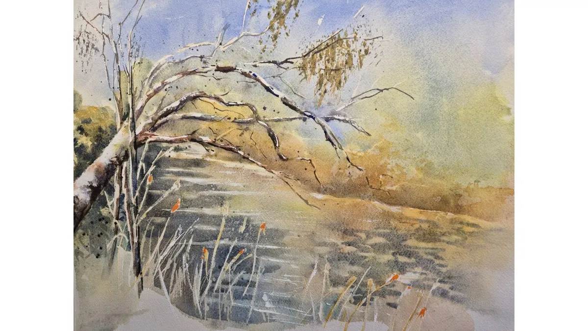 Watercolour painting of a tree leaning over a narrow stream or pond. Pale blue, grey and gold tones depict water, reeds and branches, with soft washes creating a misty background.