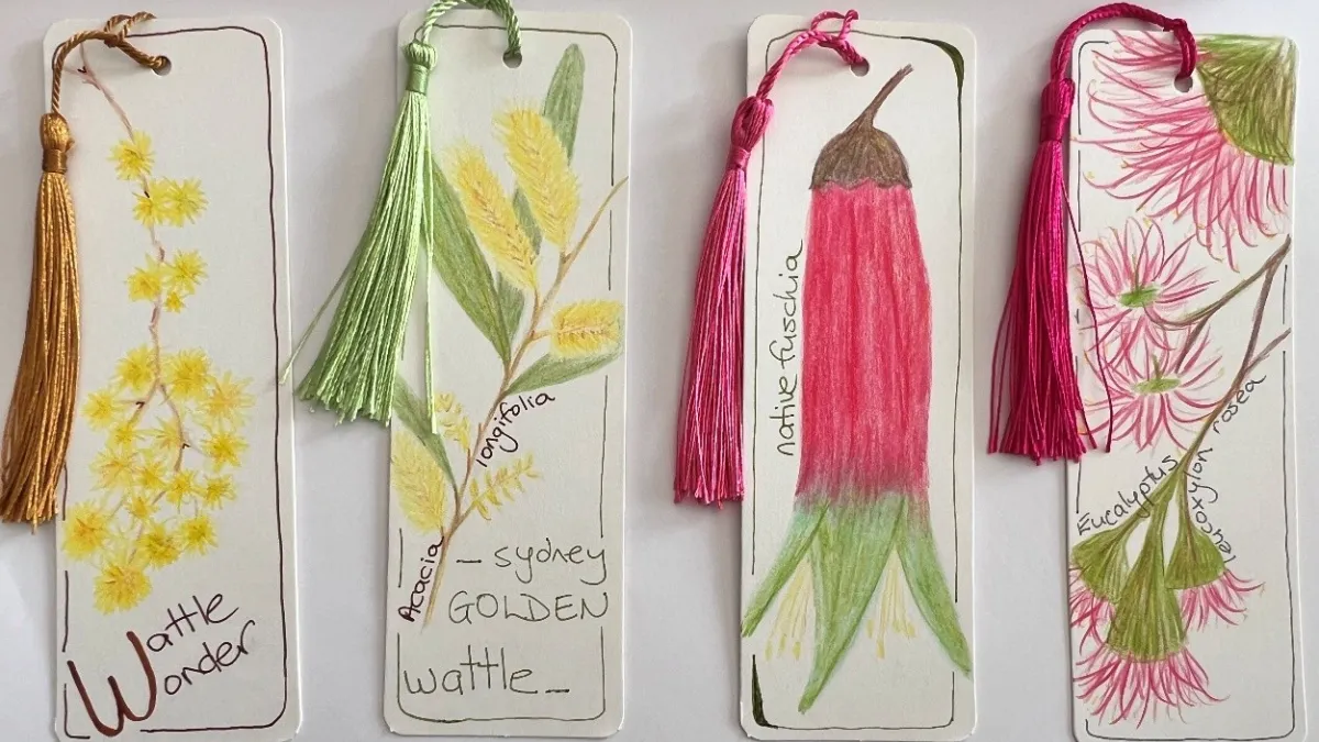 Four bookmarks with coloured tassels sit on a white background. The bookmarks show images of native flowers