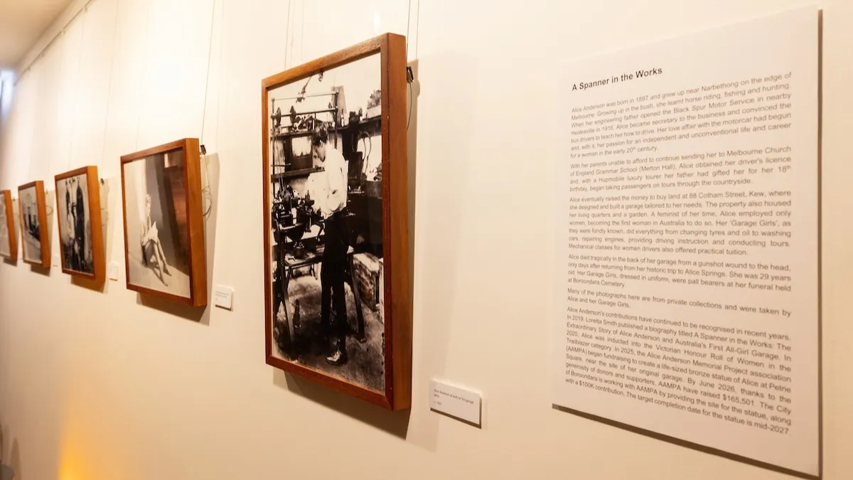 Black and white photographs installed on a white wall. 