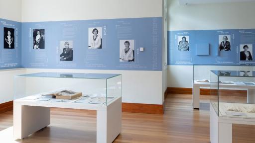 View of the Tracing Her Steps installation with photographs of former mayors in the background
