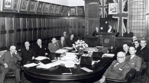 A black and white photograph of councillors sitting around a table at Kew