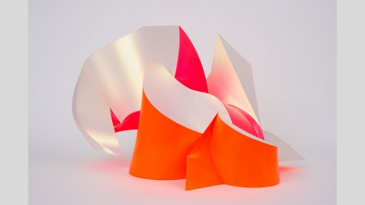 Abstract fluorescent acrylic orange and iridescent white acrylic shapes. Like snow capped mountains in the distance.