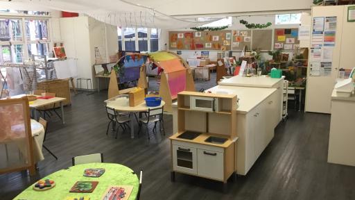 Children's play space with tables, cubby and artworks