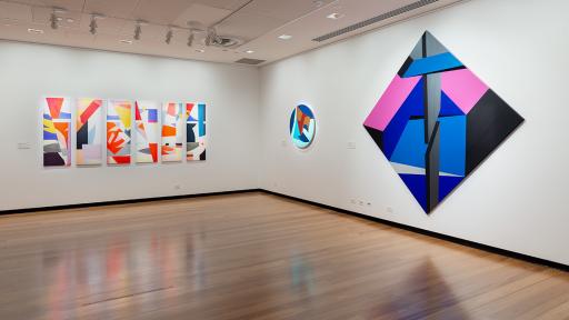 Installation view of 'Light Gestures' at Town Hall Gallery. Abstract geometric painting on the wall that are reminiscent of buildings or structures.