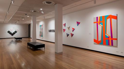 Installation view of 'Light Gestures' at Town Hall Gallery. Abstract geometric paintings on the walls.