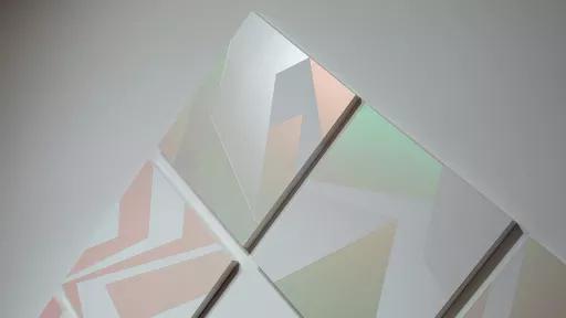 Detail of painting in 'Light Gestures: Samara Adamson- Pinczewski'. Made up of multiple small square canvas' turned to stand on their points. Painting has sharp lines and angles zig-zagging across the canvas's.