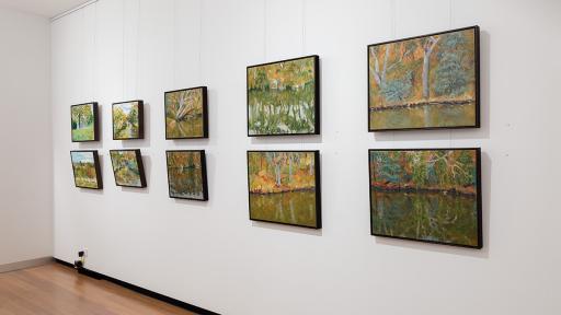 Installation view of 'Natural Constructs' at Town Hall Gallery. Paintings of water and trees by Tim Lane.