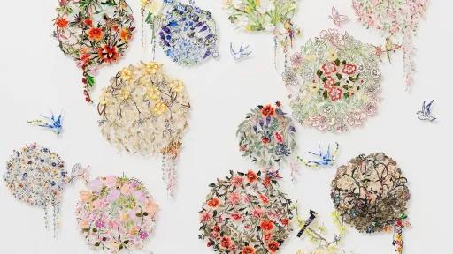 Circles of lace embroidered with reclaimed needlework of flowers and birds.