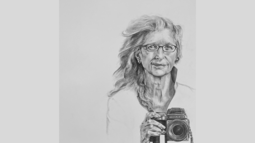 Annie Leibovitz holding a camera.