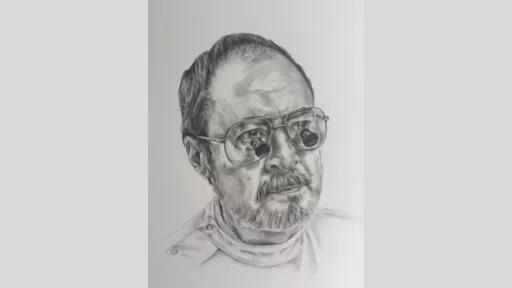 Man wearing glasses with magnifying attachments.