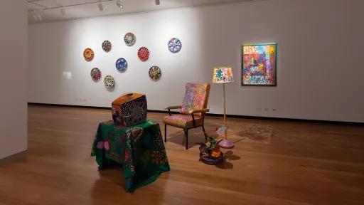 Installation view of Material Reverie at Town Hall Gallery, including a lamp, chair, television and plant made from different materials