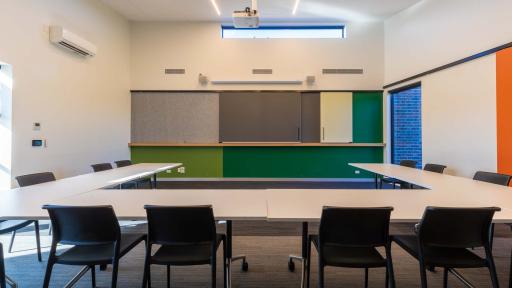 A meeting room with a large U-shaped table