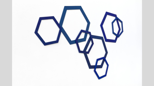 A series of blue hexagons of different sizes overlapping on a white wall