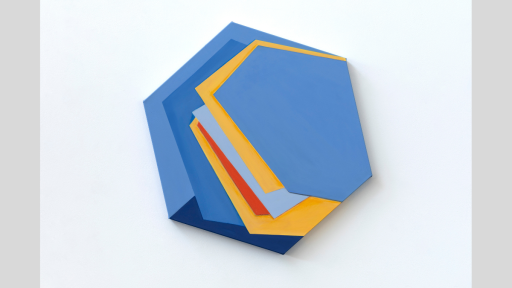 A hexagonal canvas painted to show a stack of shapes in blues, yellows, and oranges.