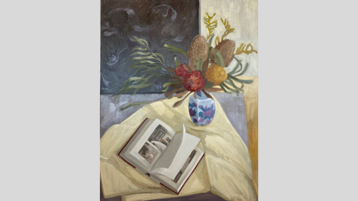 Painting of Australian native flowers in a blue vase next to an open book