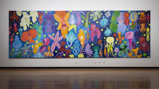 The exhibition space for Above the Canopy, showing a large painting covering most of a wall with bright multicolour flowers on a blue canvas