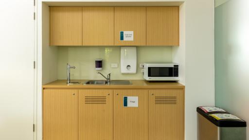 A kitchenette with microwave and sink