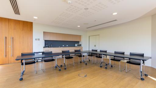 A meeting room with timber floor and L-shaped table