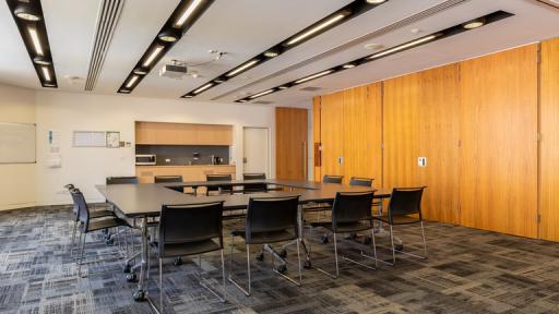 A carpeted meeting room with a wall of doors