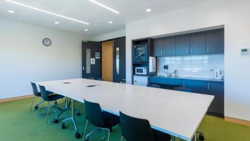 A large table takes up most of a meeting room
