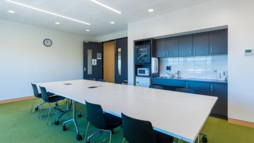 A large table takes up most of a meeting room