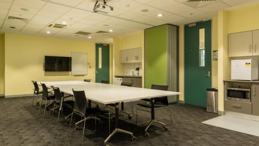 Meeting room with boardroom table and green doors